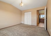 Thumbnail 37 of 64 - A room with a carpeted floor and a white door.