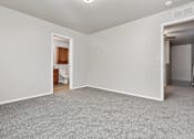 Thumbnail 41 of 60 - A room with a carpeted floor and white walls.