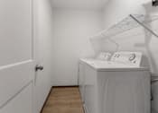 Thumbnail 15 of 44 - A laundry room with a washer and dryer.