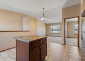 Thumbnail 41 of 64 - A kitchen with a marble countertop and tile flooring.