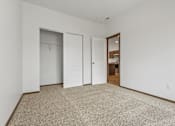 Thumbnail 50 of 54 - A room with carpeted floor and three doors.