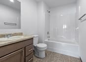Thumbnail 37 of 58 - A white bathroom with a toilet, sink, and bathtub.