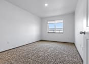 Thumbnail 33 of 58 - A room with a carpeted floor and a window.