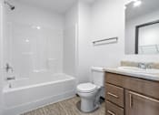 Thumbnail 40 of 58 - A white bathroom with a toilet, sink, and bathtub.