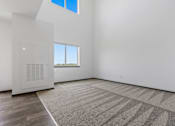 Thumbnail 12 of 57 - A room with a carpet, a window and a white door.