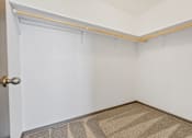 Thumbnail 16 of 57 - A room with a door and a carpet on the floor.
