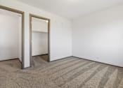 Thumbnail 14 of 57 - A room with a striped carpet and two open doors.