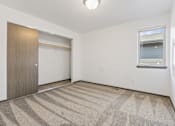 Thumbnail 22 of 57 - A room with a carpeted floor and a sliding door.