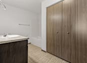 Thumbnail 20 of 57 - A bathroom with a sink, a shower, and a wooden cabinet.