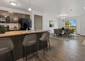 Thumbnail 1 of 57 - A kitchen with a bar area and a dining table.