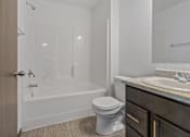 Thumbnail 24 of 57 - A white toilet sits in a bathroom next to a sink.