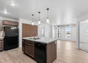 Thumbnail 10 of 44 - a kitchen with a large island and a black refrigerator