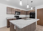 Thumbnail 7 of 44 - a kitchen with a marble counter top and wooden cabinets