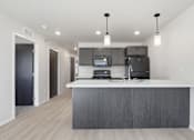 Thumbnail 9 of 68 - A modern kitchen with a large island and stainless steel appliances.