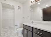 Thumbnail 42 of 68 - A bathroom with a white toilet and a white sink.