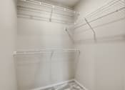 Thumbnail 38 of 68 - Empty white shelves in a room.