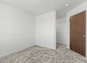 Thumbnail 37 of 44 - an empty room with white walls and a door to a closet