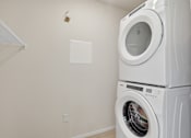Thumbnail 35 of 68 - A white dryer is stacked on top of a white washing machine.