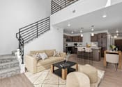 Thumbnail 1 of 44 - A living room with a staircase and a couch.