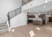 Thumbnail 16 of 44 - an open living room and kitchen with a staircase in a new home