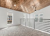 Thumbnail 17 of 44 - the upstairs loft has a wood ceiling and white walls and a balcony with railings