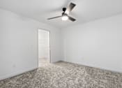Thumbnail 18 of 44 - an empty room with carpet and a ceiling fan