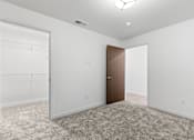 Thumbnail 20 of 44 - an empty bedroom with white walls and a door to a closet