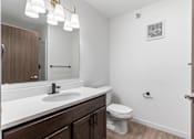 Thumbnail 19 of 44 - a bathroom with a sink and a toilet and a mirror