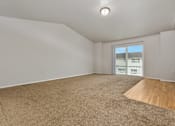 Thumbnail 56 of 60 - Empty room with carpeted floor and a window.