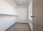 Thumbnail 38 of 47 - A room with a carpeted floor and a door on the right side.