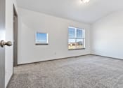 Thumbnail 41 of 47 - A room with a carpeted floor and two windows.