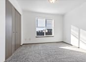 Thumbnail 25 of 47 - A room with a window and a grey carpet.