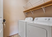 Thumbnail 44 of 64 - A white washing machine and dryer in a laundry room.