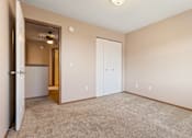 Thumbnail 48 of 64 - A room with a carpeted floor and two doors.