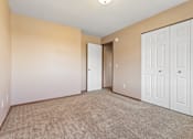 Thumbnail 46 of 64 - A room with a carpeted floor and white doors.