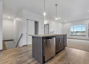 Thumbnail 52 of 54 - A modern kitchen with a large island and stainless steel appliances.