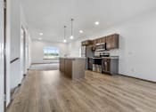 Thumbnail 11 of 54 - A kitchen with wooden floors and stainless steel appliances.