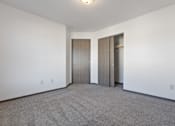 Thumbnail 44 of 47 - A room with a carpeted floor and two doors.