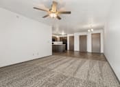 Thumbnail 40 of 59 - A room with a ceiling fan and carpeted floor.