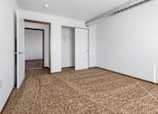 Thumbnail 25 of 44 - A room with a carpeted floor and white walls.