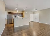 Thumbnail 40 of 54 - A kitchen with wooden floors and white walls.