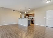 Thumbnail 39 of 54 - A kitchen area with a white countertop and wooden flooring.