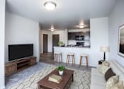 Thumbnail 2 of 16 - A living room with a television, a couch, and a coffee table.