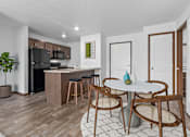 Thumbnail 4 of 38 - A kitchen with a table and chairs in the middle of the room.