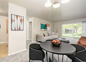 Thumbnail 9 of 41 - A modern dining room with a round table and chairs.