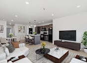 Thumbnail 15 of 68 - A modern living room with a white sofa, a black coffee table, and a flat-screen TV.