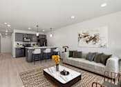 Thumbnail 1 of 68 - A modern living room with a kitchen in the background.