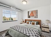 Thumbnail 2 of 21 - A bedroom with a large bed and a window overlooking a landscape.