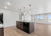 Thumbnail 27 of 44 - the living room and kitchen in a new home with white walls and wood floors