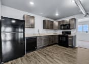 Thumbnail 16 of 35 - open kitchen with black appliances